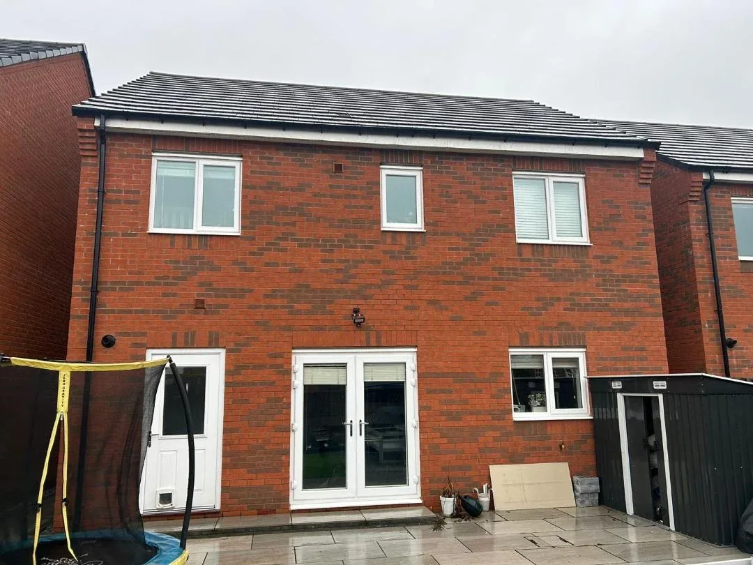 Rear of a brick house with a plain tiled roof before a dormer was built.