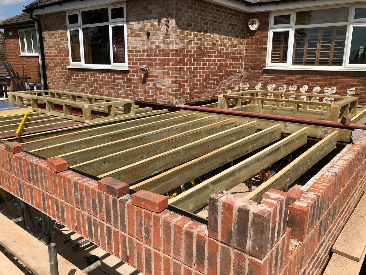 Timber joists and a framed opening over new brickwork.
